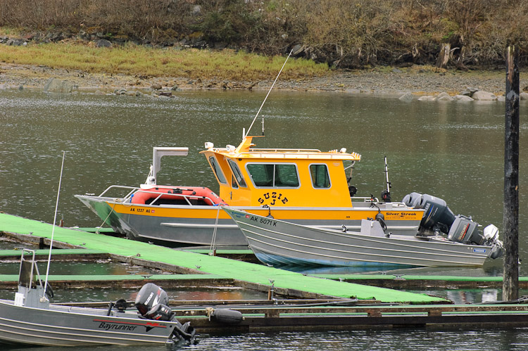 A brightly colored fishing boat docked in a wharf in Juneau, Alaska
